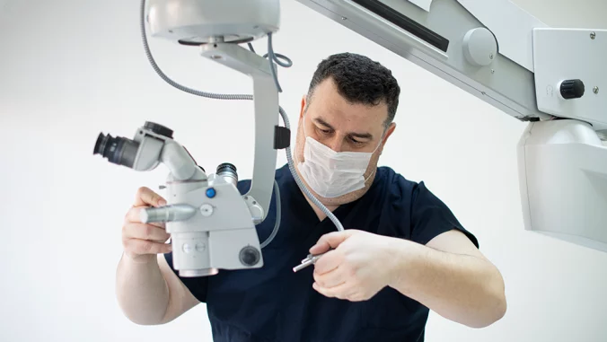 Biomedical equipment technician working on medical device repair in healthcare facility